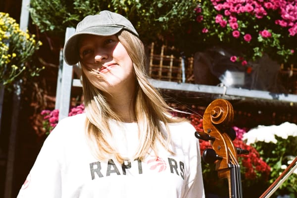 Eliza Niemi in a garden with her cello