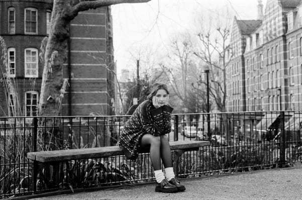 gglum sitting on a park bench